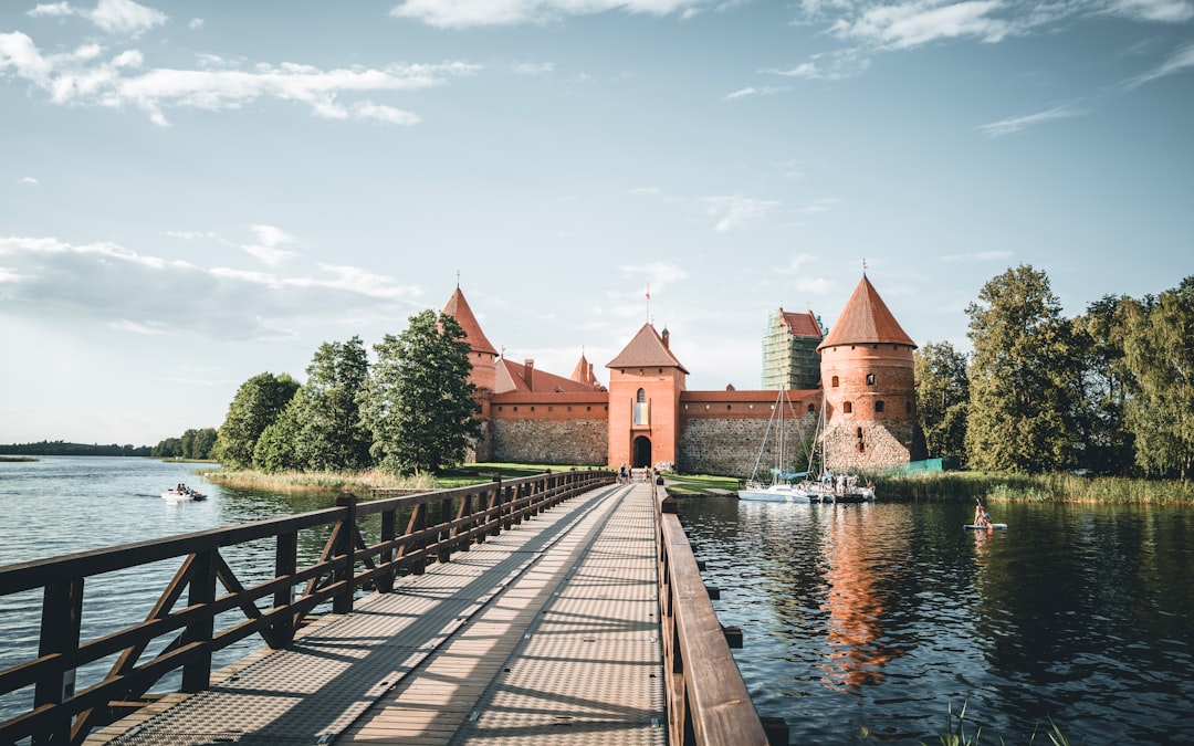 A bridge over a body of water with a castle in the background