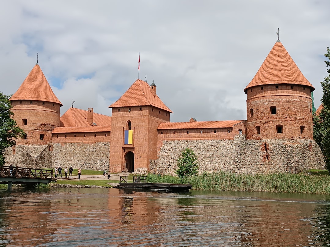 A large brick building sitting next to a body of water